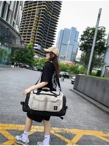 Large capacity travel duffel bag for gym, business trips, waterproof canvas shoulder bag.