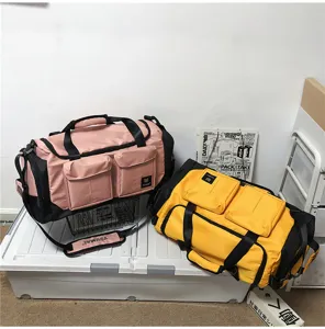 Detail view of large capacity travel duffel bag with multiple front pockets and sturdy straps.