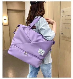 Detailed view of large purple travel duffel bag, lightweight gym tote with wet dry separation.