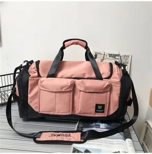 Large capacity pink travel duffel bag with black contrast, multi pockets and shoulder strap.