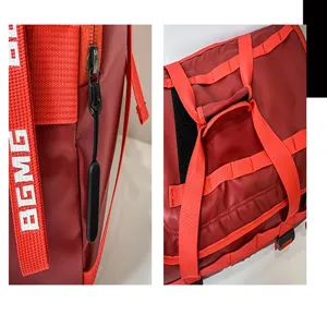 Close-up detail shot of red travel bag showing durable zipper, hardware and strap with print.