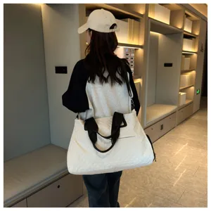 Large capacity quilted travel duffel bag for women, stylish shoulder weekend bag.