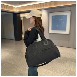 Large capacity black quilted travel bag for women, stylish and casual shoulder duffel bag.
