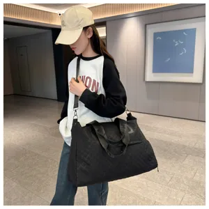 Large capacity black quilted travel duffel bag for women, perfect for weekend trips and gym.