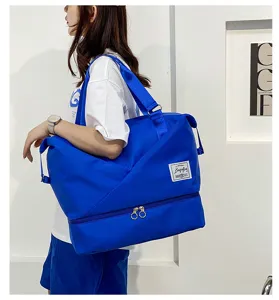 Large capacity blue travel duffel bag with wet dry separation compartment and shoulder strap.