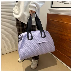 Large capacity quilted travel duffel bag for women, stylish purple shoulder bag for trip.