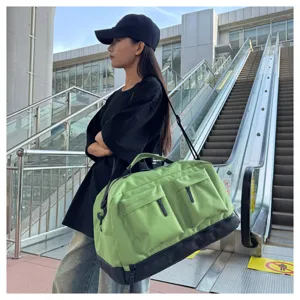 Large capacity green travel duffel bag detail view with multiple pockets and shoulder strap.