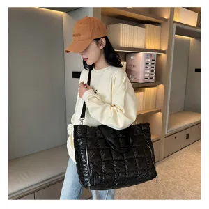 Black quilted puffer tote bag detail, casual nylon shoulder gym bag for travel and daily use.