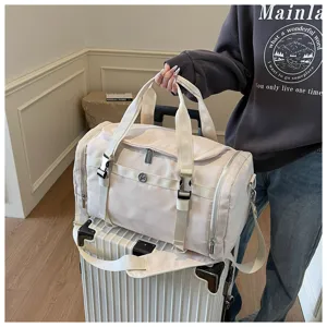 Lightweight beige travel duffel bag with large capacity and wet-dry separation design.
