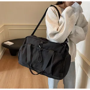 Large capacity black travel duffel bag, lightweight waterproof gym bag for women daily use.