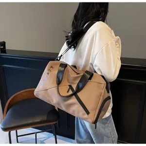 Large capacity travel duffel bag for women, waterproof gym bag with shoulder strap.