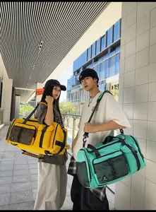 Detailed view of large capacity travel duffel bag in yellow and green with multi compartments.