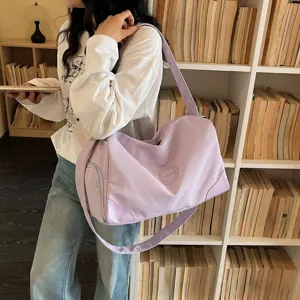 Lightweight purple travel duffel bag for women, large capacity fitness gym bag with wide strap.