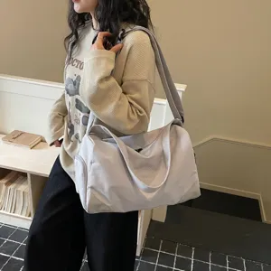 Lightweight grey duffel bag for women, large capacity sports gym bag for travel and fitness.