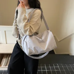 Spacious casual grey travel duffel bag for women, large capacity shoulder gym bag with wide strap.