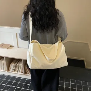 Large capacity canvas travel bag for women, lightweight gym and weekend duffel bag.