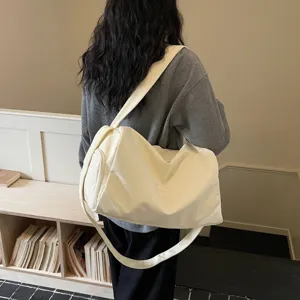 Large capacity canvas gym duffel bag for women, stylish travel shoulder bag with wide strap.