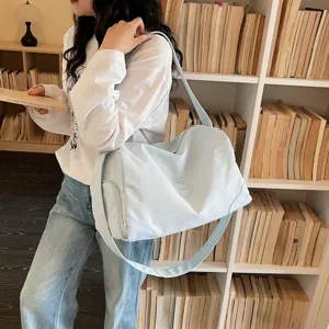 Light blue large capacity gym duffel bag for women, portable travel sports bag detail view.