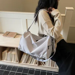 Large capacity grey gym duffel bag for women, lightweight travel shoulder bag for sports.