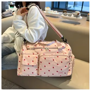 Pink corduroy travel duffel bag with cute strawberry print, large capacity and pockets for women.