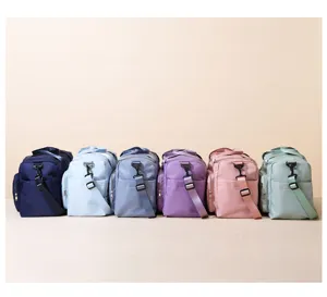 Detailed view of large capacity multi-color travel duffel bags with adjustable straps.
