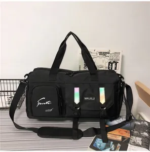 Detail view of the black travel duffel bag, showing durable fabric, sturdy handles and pockets.