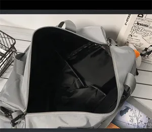 Gray travel duffel bag detail showing spacious interior compartment and durable zipper.
