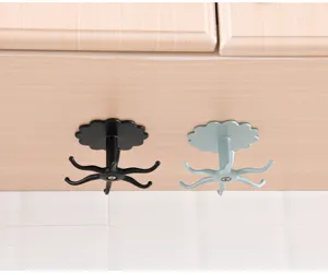 Detail view of rotating multi-hook plastic hanger mounted under cabinet, compact space saver.