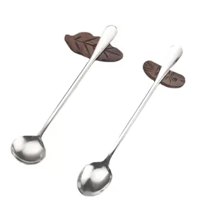 Stainless steel long handled coffee spoon with creative wooden leaf and fish design decor.