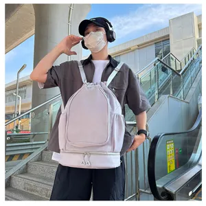 Detail view of the drawstring sports backpack, showing lifestyle wearing and outdoor setting.