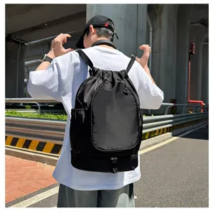 Detail view of the black drawstring sports backpack showing its large storage capacity.