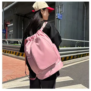 Pink drawstring backpack detail view, large capacity sports gym bag for fitness and outdoor use.
