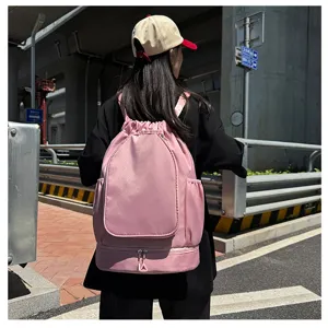 Pink drawstring sports backpack detail, featuring bottom shoe compartment and durable fabric.