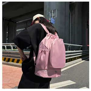 Pink drawstring sports backpack with large capacity for basketball and fitness in detail view.