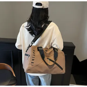 Large capacity travel duffel bag for women waterproof fitness sports bag detail shot with strap.