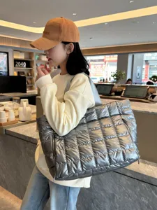 Stylish silver metallic quilted puffer tote bag, large capacity casual shoulder bag for travel.