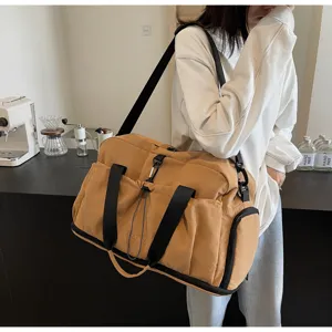 Detailed view of the large capacity travel duffel bag with multi pockets and shoulder strap.