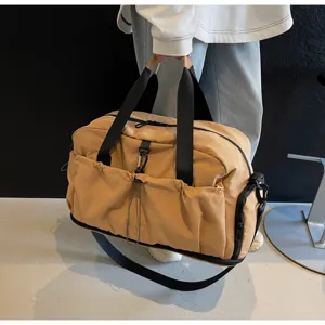 Detail view of large capacity travel duffel bag, lightweight waterproof gym bag with sturdy handles.