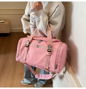 Detail shot of the large pink travel gym bag featuring durable zippers, buckles, and handles.