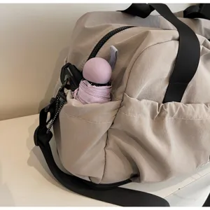 Detailed view of the travel duffel bag showcasing its convenient side pocket and durable fabric.