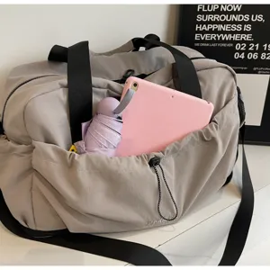 Large capacity travel duffel bag for women, lightweight waterproof fitness gym shoulder bag.