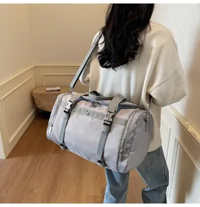 Lightweight grey travel duffel bag with large capacity, durable fabric and practical design.