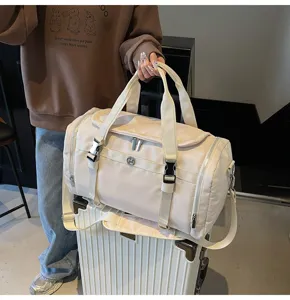 Detailed view of large capacity beige travel duffel bag with dry wet separation and straps.