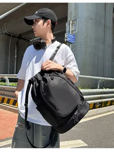 Large capacity black drawstring sports backpack with bottom compartment for gym and sports.