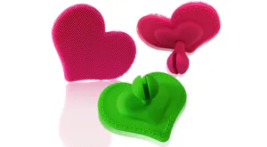 Silicone heart facial cleansing brush detail, soft bristle makeup remover tool display.