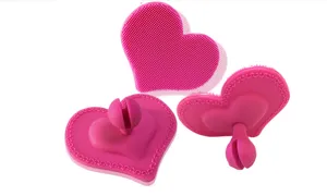 Heart shaped silicone facial cleansing brush detail showing soft bristles and base.