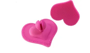 Pink heart-shaped silicone face cleaning brush with soft bristles and stable holder for daily skin care.