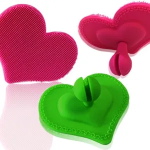 Heart-shaped silicone facial cleansing brush, soft bristle skin care scrubber tool for daily use.