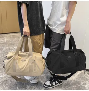 Large capacity waterproof travel duffel bag with shoulder strap for sports and gym use.