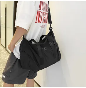 Detailed view of the large capacity black travel shoulder bag showing durable fabric and straps.
